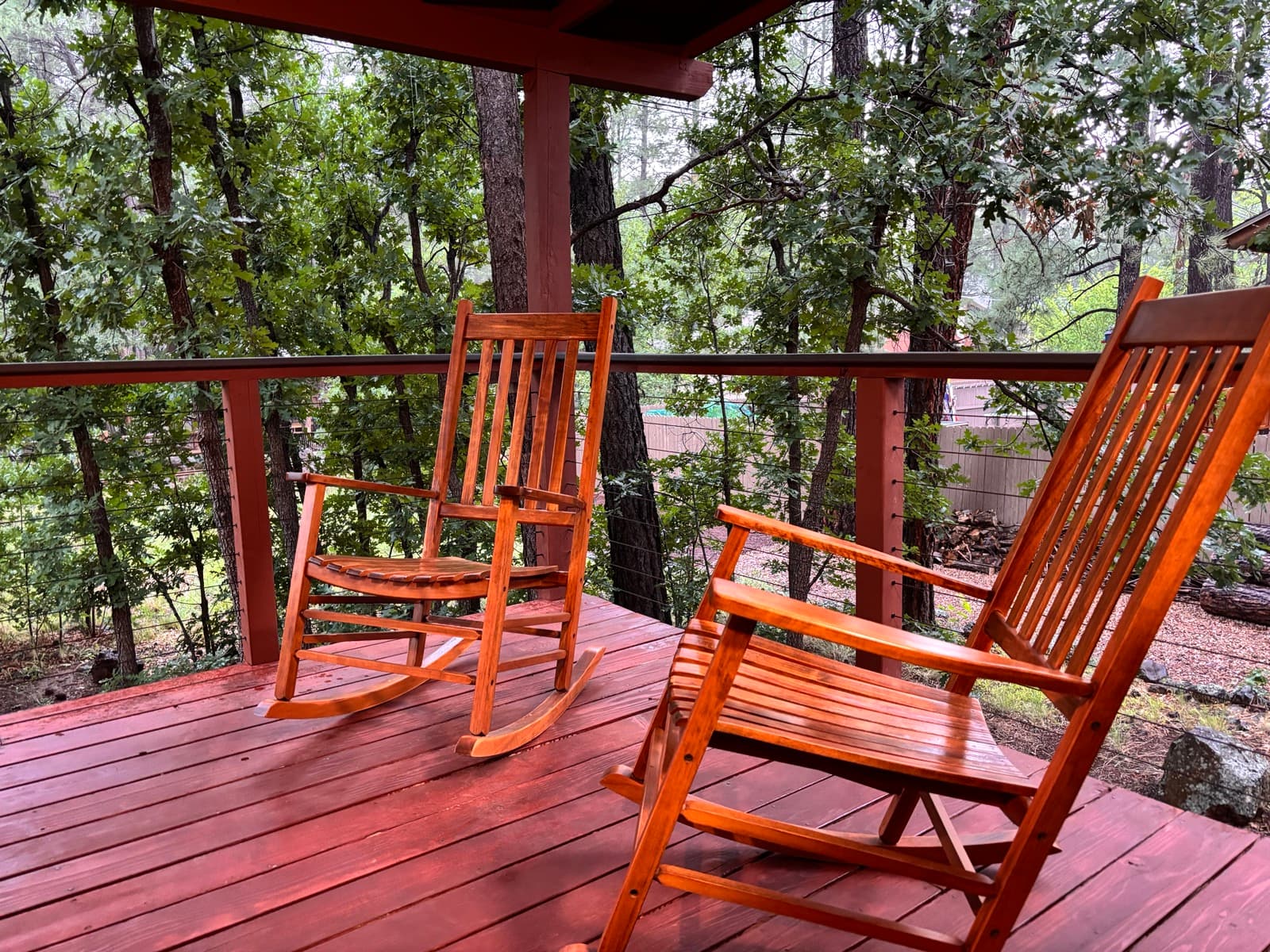 Porch rocking chairs overlooking the pines at Peaceful Pines